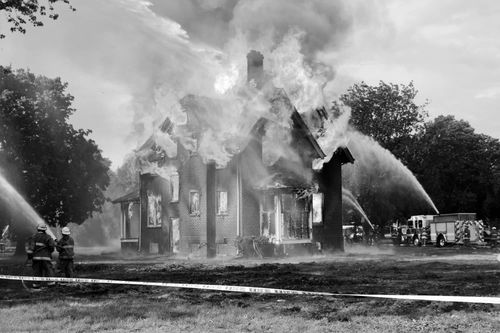 Seward Volunteer Fire Department managing a controlled fire of a house before it gets bulldozed.