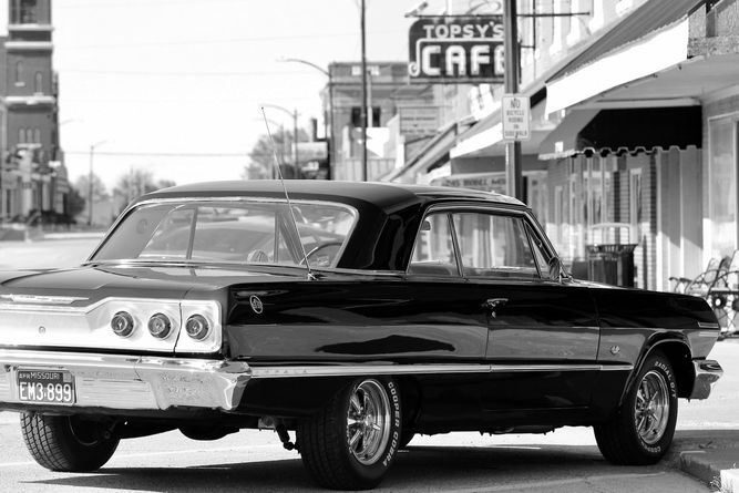 Topsy's Cafe in downtown Concordia, Missouri with an old car out front.