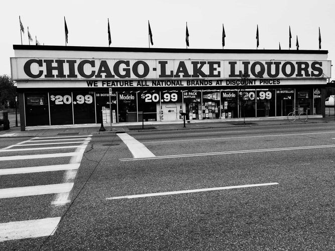 Chicago Lake Liquors store with flags topping the building.