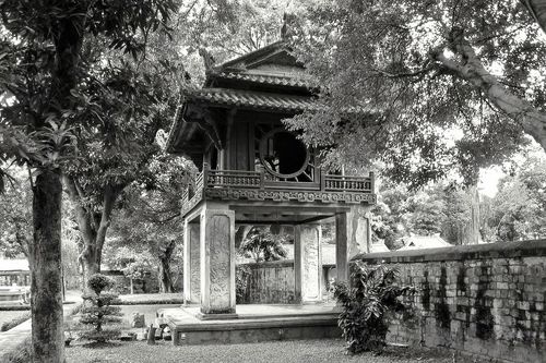 Temple of Literature in Hanoi, surrounded by trees and a wall.